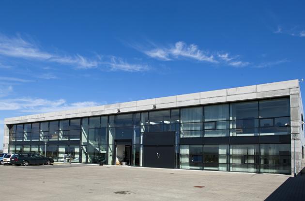 Magazine building with cars parked in front