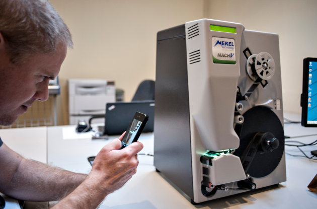 Avis Microfilm reader is photographed with a mobile phone