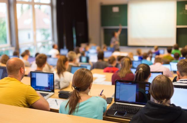 Students with laptops in lecture hall