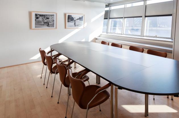 Table, chairs and pictures in the meeting room Rifbjerg