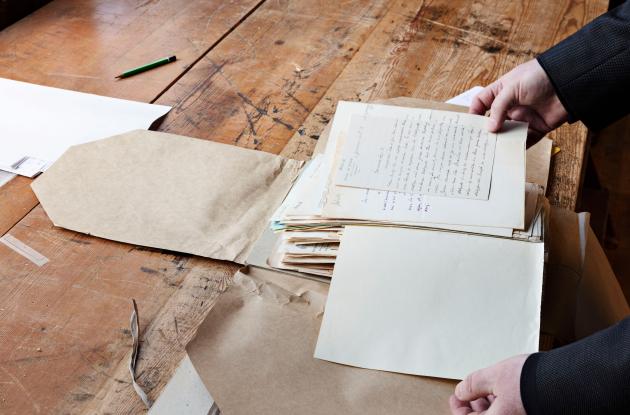 Open folder with manuscripts being reviewed. Det Kgl. Bibliotek