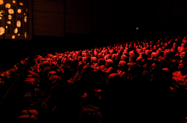 Audience bathed in red light. The Queen's Hall, The Black Diamond