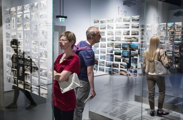 People look at postcards in exhibition