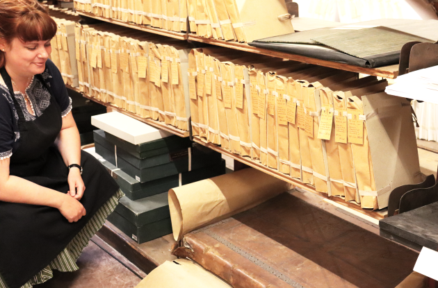 Employee amongst archive shelves