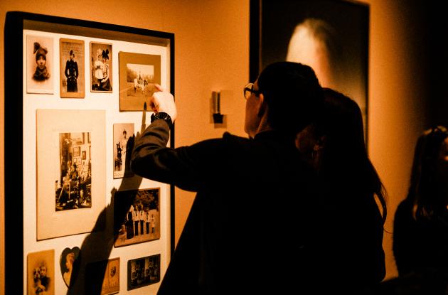 Photograph of people looking at photographs