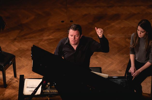 Photo of pianist Jens Elvekær playing the piano at a concert.