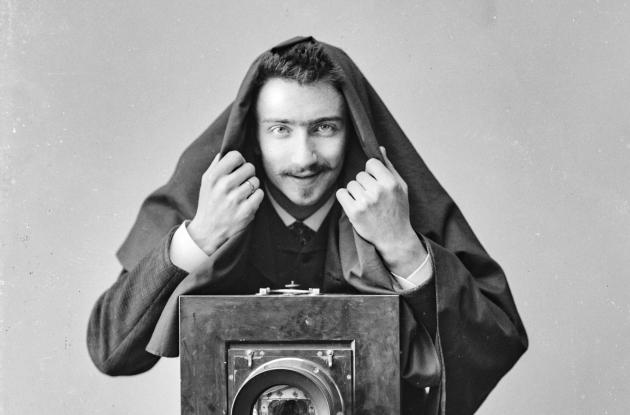 Elfelt stands with a large camera and cloth over his head.