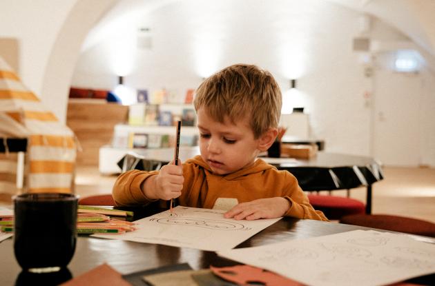 Picture of boy drawing at the Children's Library
