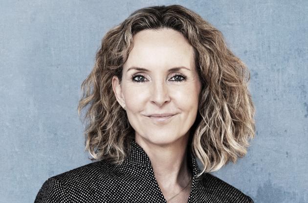 Billede af Vibeke Koushede med en grå baggrund.
