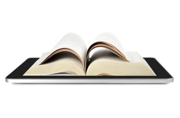 Open book lying on tablet