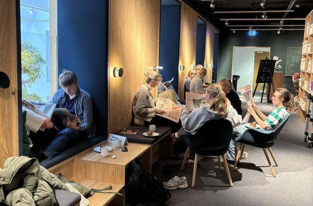 Photo of newspaper readers from a previous newspaper reading event
