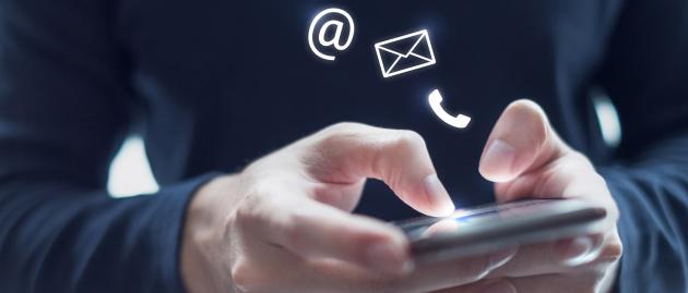 Hands operate mobile phone with contact symbols