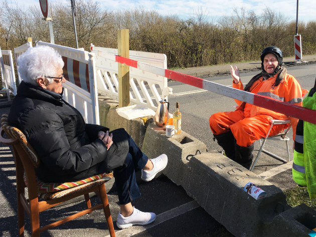 Two people meet at the border barrier between Denmark and Germany 2020