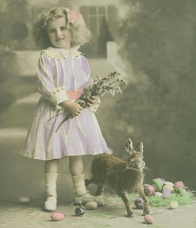 Girl with bouquet of flowers standing next to a hare