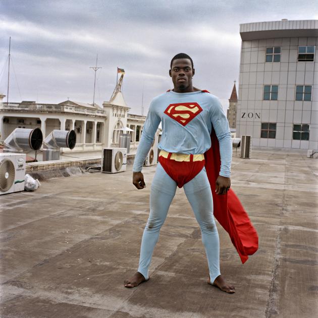 A black man wearing a Superman costume