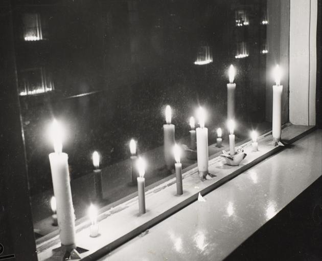 Photograph of candle in window sill.