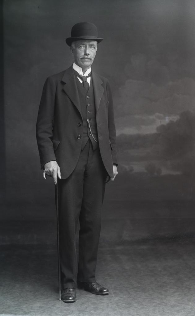 Portrait of man with hat and walking stick