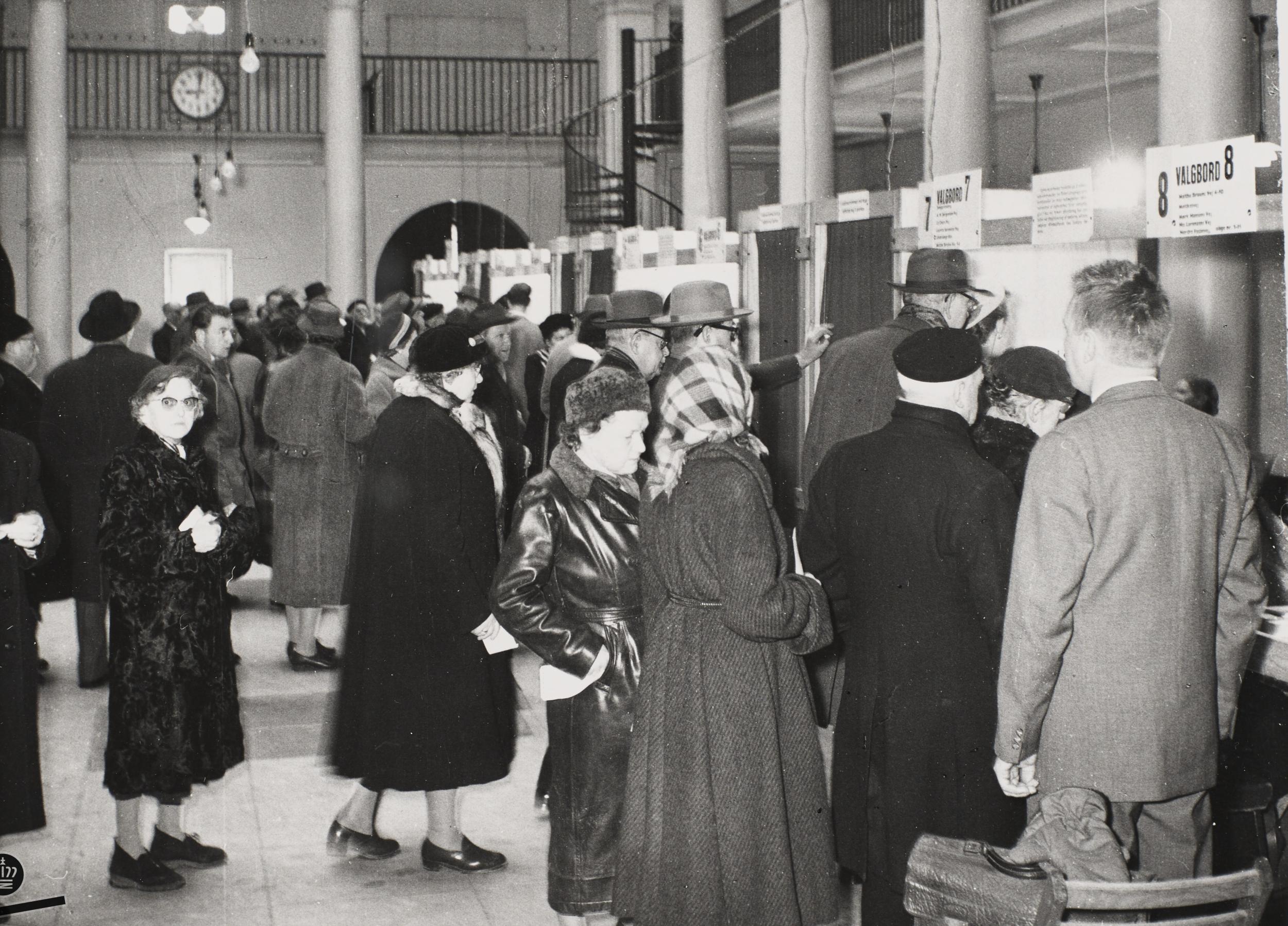 Men and women queuing at the polling booths