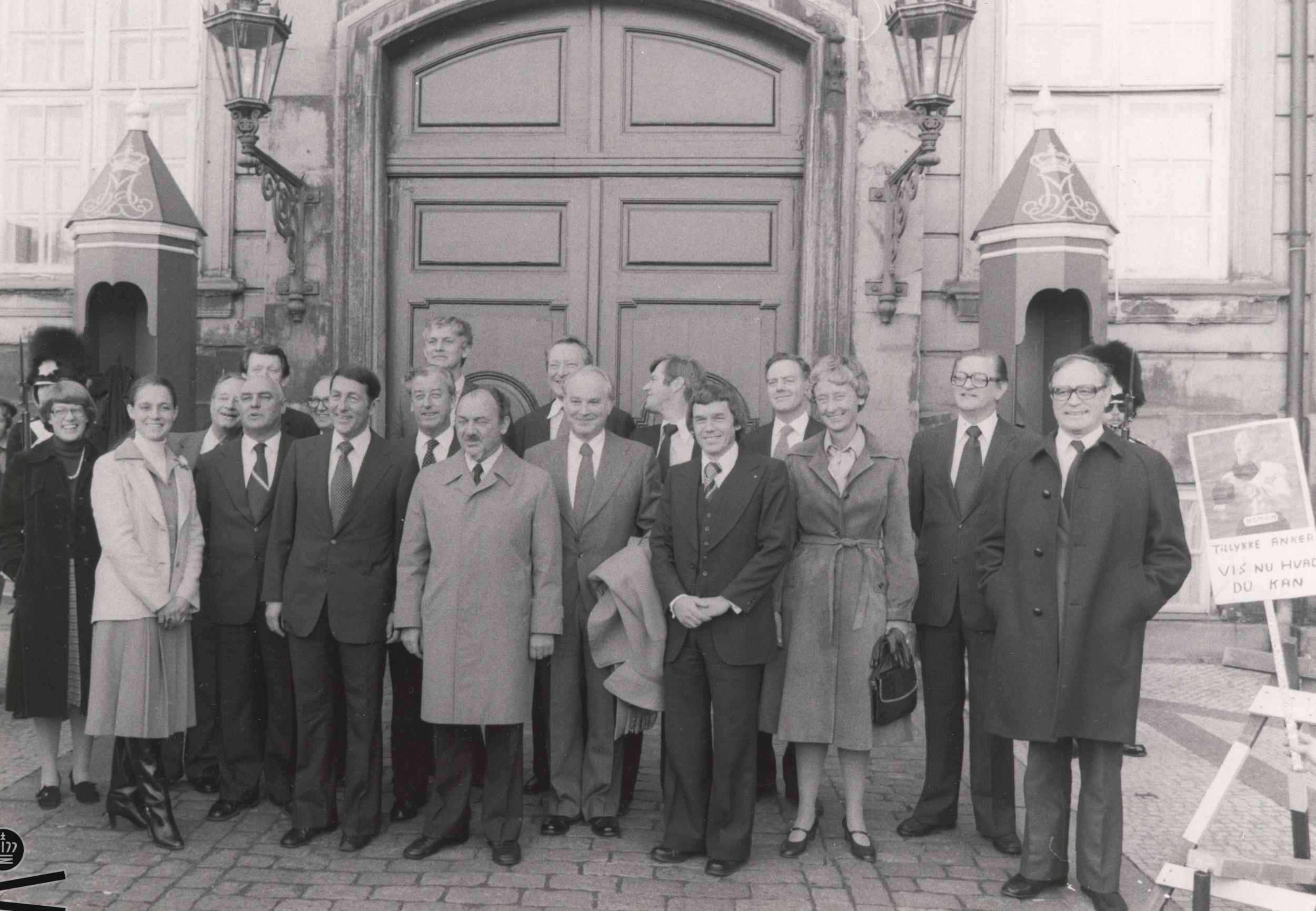 The new government officials pose for a photo in front of the door