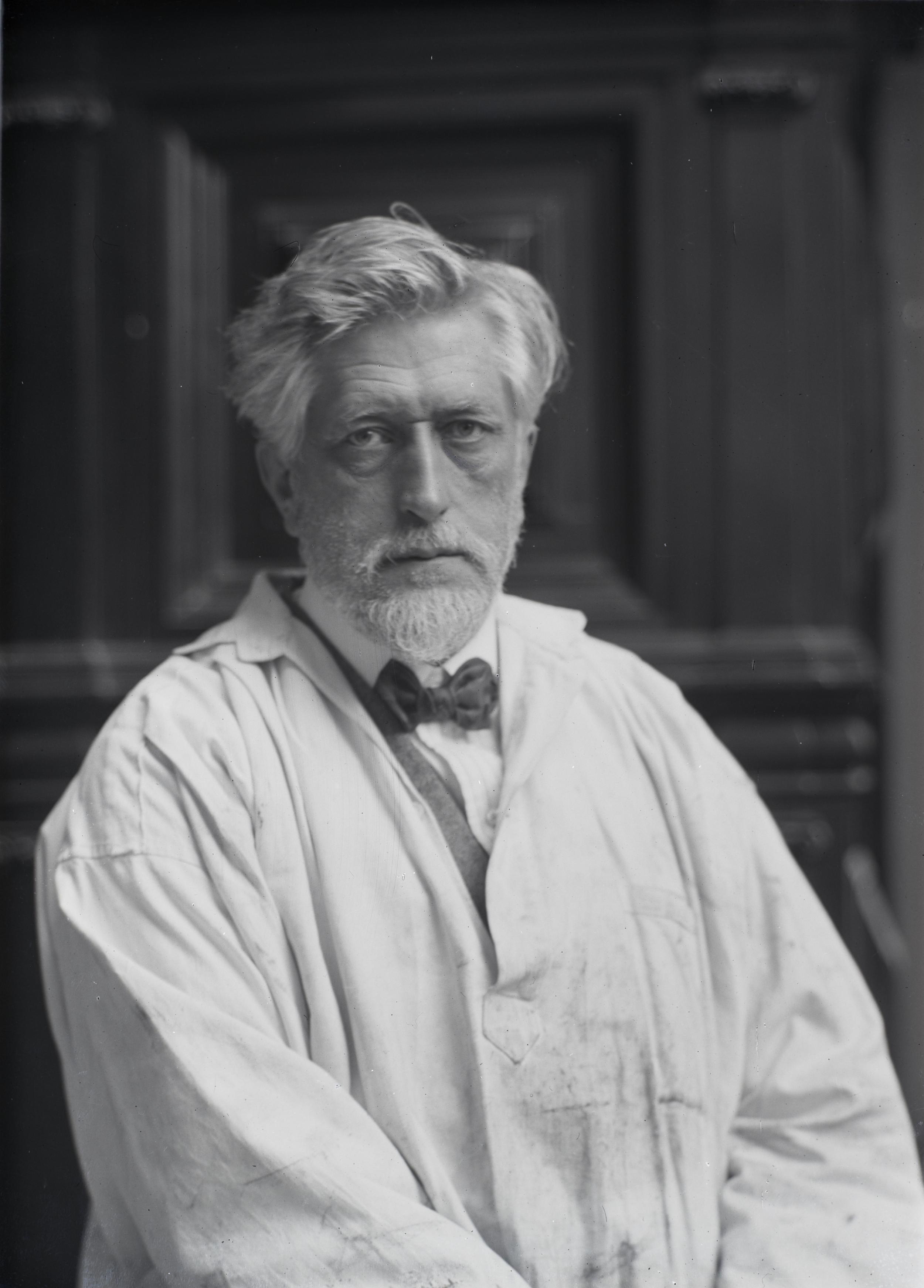 Man wearing white coat and bow tie