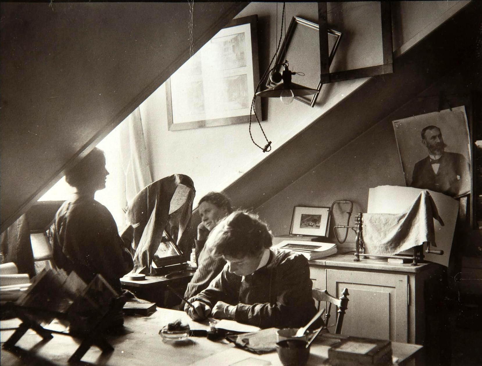 Three women sitting in a work room