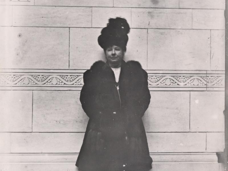 The first woman to vote at Copenhagen City Hall is wearing a nice coat and hat