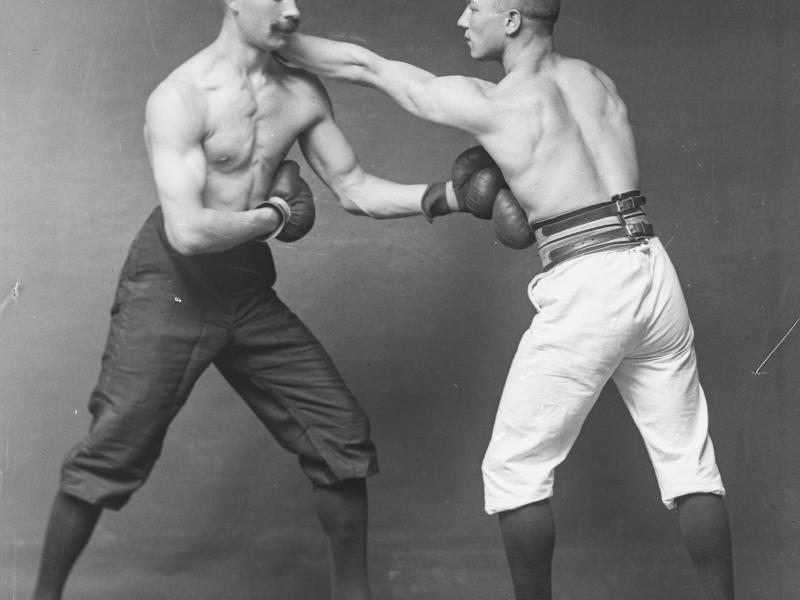 Fotografi af to mænd, der bokser.
