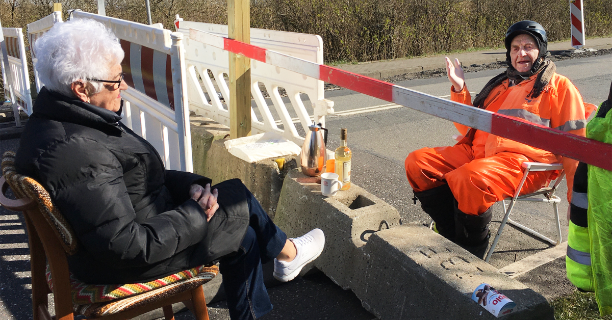 Two people meet at the border barrier between Denmark and Germany 2020